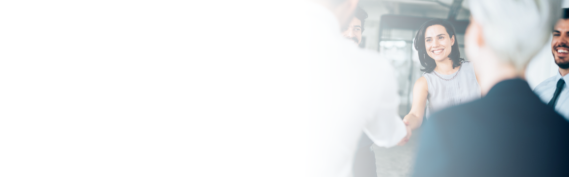 a woman shaking hands. Image fading to white to the left